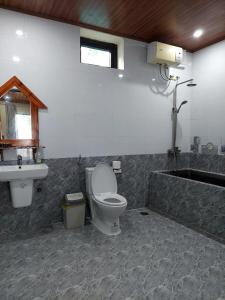 a bathroom with a toilet and a sink at Restful River Villas in Phong Nha