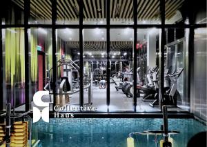 a gym with a swimming pool in a building at Tropicana Residence Kuala Lumpur by Collective Haus in Kuala Lumpur