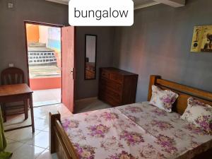 Antsakomboena的住宿－VILLA FPC，一间卧室配有一张床、一个梳妆台和一扇窗户。