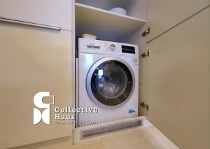 a washer and dryer in a laundry room at Tropicana Residence Kuala Lumpur by Collective Haus in Kuala Lumpur