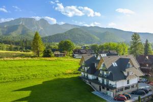 an aerial view of a house with mountains in the background at Aparthotel Zakopane in Zakopane