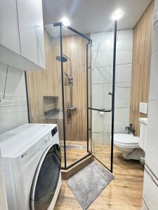 una lavatrice in un bagno con doccia di Элитный апартамент в центре города Мега центр a Almaty