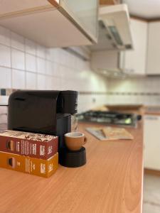 a coffee maker on a counter in a kitchen at Casa Matilde piano terra 100mq con parking e piscina in Ferrara +14 photos