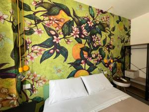 ein Schlafzimmer mit einer Wand mit Blumentapete in der Unterkunft 'Na Pace dei Santi B&B in Porto SantʼElpidio
