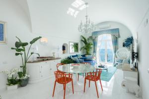 a kitchen and living room with a table and chairs at Villa Navarra in Praiano