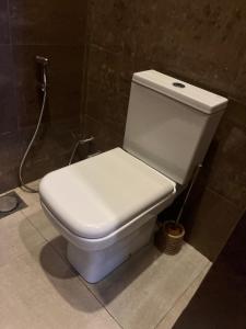 a white toilet in a bathroom with a hose at Binta Boutique Hotel in Nungwi