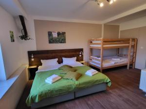 a bedroom with a bed and a bunk bed at Gutshof Kehnert - Pension & Ferienwohnungen in Kehnert