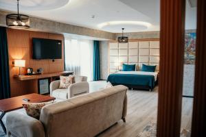 a hotel room with a bed and a couch at Grand Vaves Hotel in Trabzon