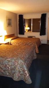 a hotel room with a large bed in a room at National 9 Inn in Tonopah