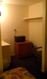 a room with a bed and a microwave on a table at National 9 Inn in Tonopah