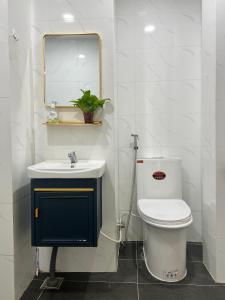 a bathroom with a toilet and a sink and a mirror at Private Homestay District 1, Tan Ðinh Ward, HCM City in Ho Chi Minh City