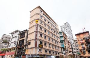 a tall building with a clock on the side of it at Itsy Hotels Elegant in Mumbai