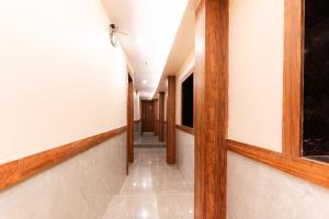 a hallway with wood trim and white walls at Itsy By Treebo - Elegant in Mumbai