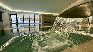 a fountain in the middle of a building at CP Top floor luxury studio with spa and pool in Gibraltar