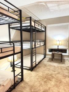 a room with three bunk beds and a table at Datu - Discover world with us in Newport Beach