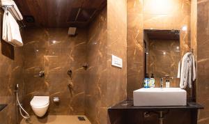 a bathroom with a sink and a toilet at Itsy Hotels Elegant in Mumbai