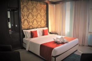 a bedroom with a bed with a flower on it at GEETANJALI REGENCY in kolkata