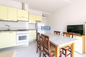kuchnia ze stołem i krzesłami w pokoju w obiekcie Residence Adriatica w mieście Lido di Jesolo