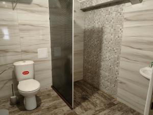 a bathroom with a toilet and a sink at стаи за гости TODA in Troyan +31 photos