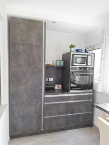 a kitchen with a oven and a microwave at APARTMENT NEVERA in Rijeka