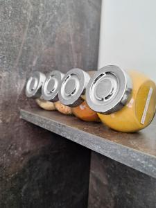a shelf with cans of coke on top of oranges at APARTMENT NEVERA in Rijeka