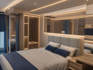 a bedroom with a large bed with blue pillows at Grandboutique-Inn in Jakarta +85 photos