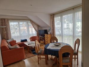 a living room with a table and a couch at Apartment Traunkai Zauner Blick in Bad Ischl