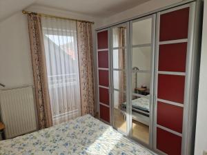 a bedroom with a bed and a large mirror at Apartment Traunkai Zauner Blick in Bad Ischl