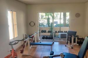 einen Fitnessraum mit mehreren Trainingsgeräten in einem Raum in der Unterkunft Isla de Altea Sol Y Mar in Altea