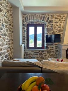 a room with a bed with fruit on a table at Traditional Cottage in Veliés +22 photos