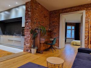 a living room with a brick wall at Riverside Retreat on Parkowa in Wrocław