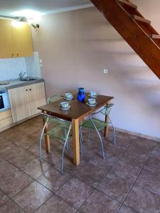 a wooden table and chairs in a kitchen at Μεζονέτα AIKATERINI N 9 in Chios