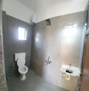 a bathroom with a toilet and a sink at EMPYREAN STAY ll 4BHK ll LEONCINO VILLA ll LARGEST POOL ll BBQ II VIEW in Lonavala