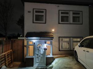 a house with a blue door in front of it at home from home in Erith