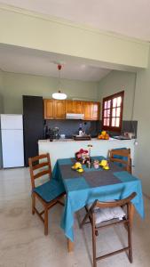 a kitchen with a table with a blue tablecloth on it at Holiday apartment near the sea in Melission