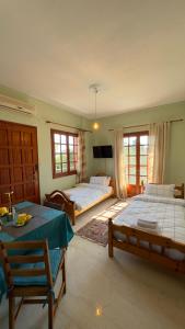 a bedroom with two beds and a table and chairs at Holiday apartment near the sea in Melission