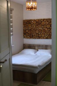 a bed in a room with a wall of logs at Qimiz.Uz in Chimgan