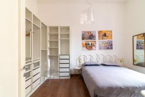 a white bedroom with a bed and a closet at Luxury apartment near via veneto in Rome