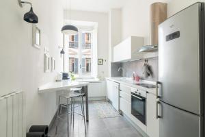 a kitchen with white appliances and a refrigerator at Luxury apartment near via veneto in Rome