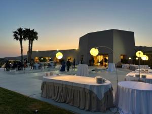 a group of tables in front of a building at Desusino Residence & Hotel in Butera