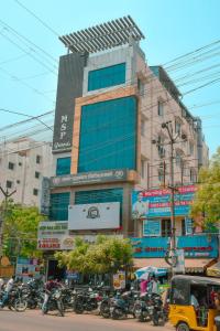 a building with motorcycles parked in front of it at MSP Grands Inn in Madurai