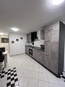 a kitchen with stainless steel appliances and a tile floor at Elpe in Olsberg