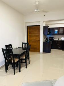 uma sala de jantar com mesa e cadeiras e uma cozinha em Lovish luxury villa em Colombo