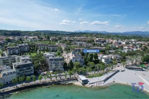 an aerial view of a city with a beach and buildings at Marriott Imperium DesenzanoLoft Official Partner Homes & Villas by Marriott Bonvoy in Desenzano del Garda
