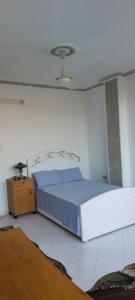 een slaapkamer met een bed en een nachtkastje bij Cozy Room with beautiful view In sheikh Zayed in Sheikh Zayed