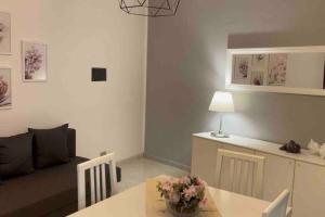 a living room with a couch and a table at Appartamento centrale a Soverato in Soverato Marina