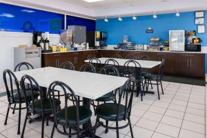 a restaurant with tables and chairs in a kitchen at Days Inn by Wyndham Forsyth in Forsyth