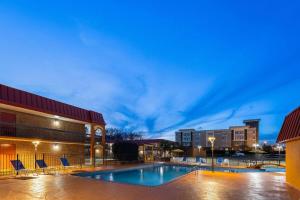 a swimming pool in front of a building at Days Inn by Wyndham Forsyth in Forsyth