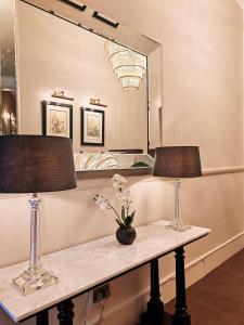 two lamps on a table in front of a mirror at Frederick House Hotel in Edinburgh +30 photos