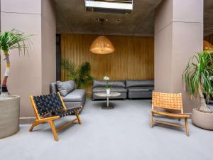 a lobby with a couch and chairs and a table at Hotel Sofitel Los Angeles at Beverly Hills in Los Angeles